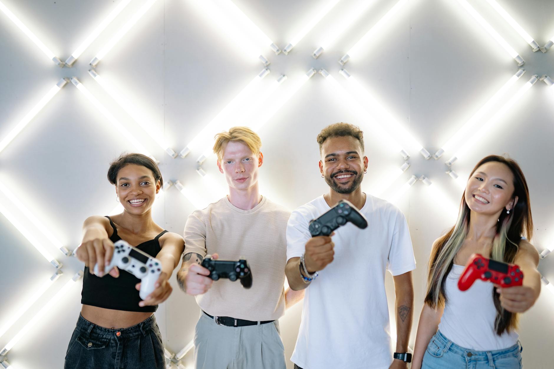 A diverse group of people smiling in a bright yoga studio